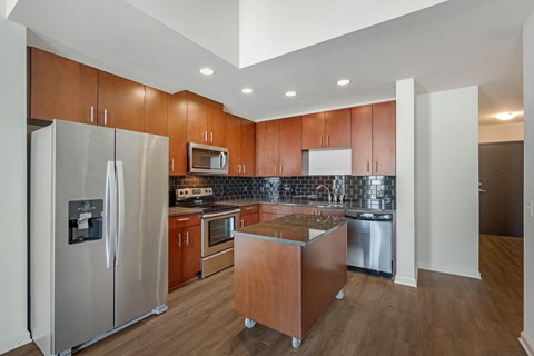 A kitchen with wooden cabinets and stainless steel appliances