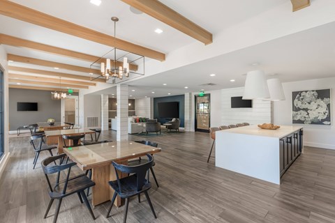 A modern dining room with a long table and chairs.