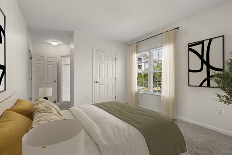 A bedroom with a large bed and a window with curtains.