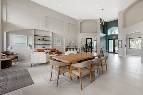 A modern dining room with a wooden table and chairs.