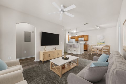 A living room with a grey couch and a wooden coffee table.