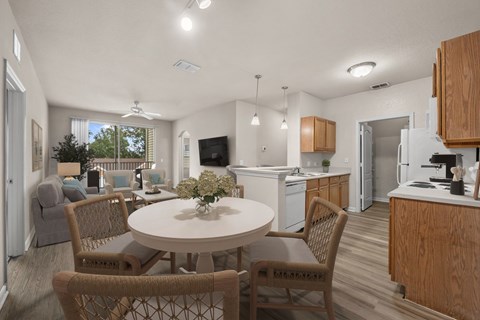 A kitchen with a table and chairs in the middle of the room.
