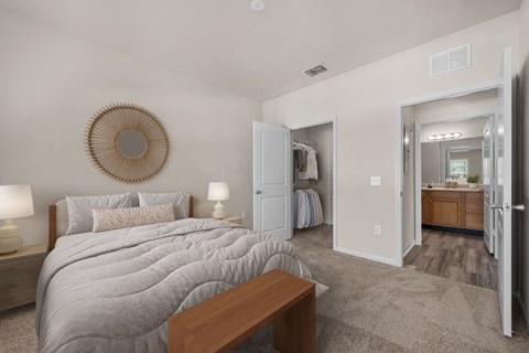 A bedroom with a large bed and a wooden bench.