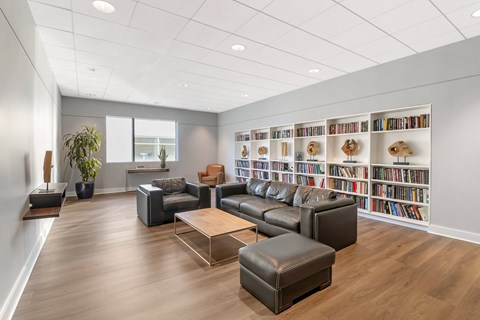 A living room with a large bookshelf filled with books.