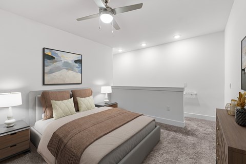 A bedroom with a bed, nightstands, and a painting on the wall.
