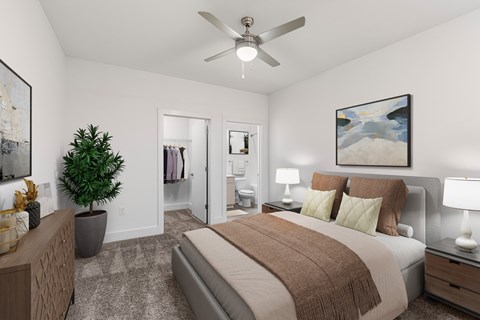 A bedroom with a bed, a ceiling fan, and a painting on the wall.