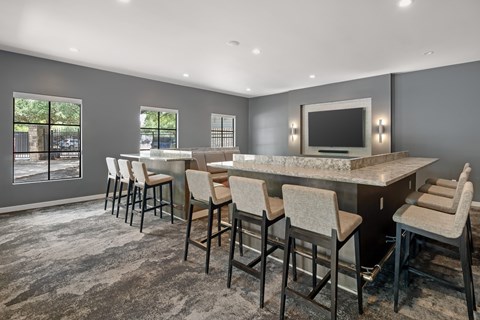 A modern dining room with a large table and chairs.