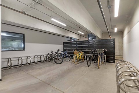 A bike parking area with bicycles parked in metal racks.