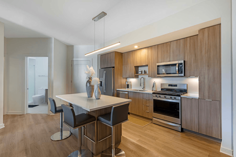 A modern kitchen with a dining table and chairs.