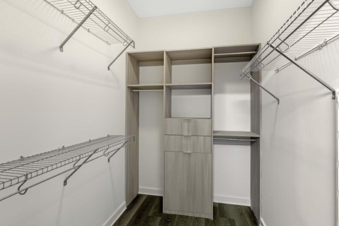 A walk-in closet with shelving and hanging space.