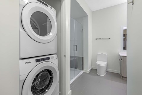 A white Whirlpool washing machine in a laundry room.