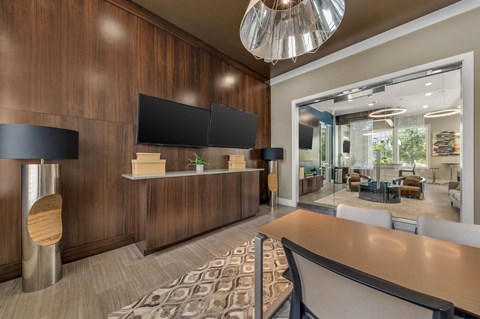 A modern office space with a reception desk and a large mirror on the wall.