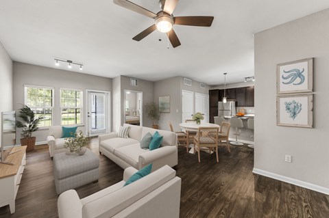 A living room with a white couch and a ceiling fan.