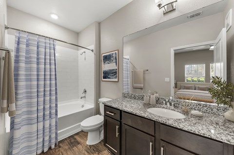 A bathroom with a toilet, sink, and shower.