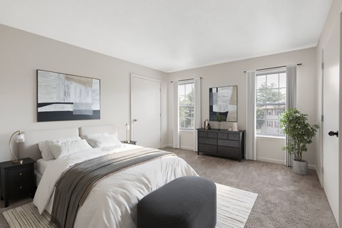 A bedroom with a large bed and a painting on the wall.