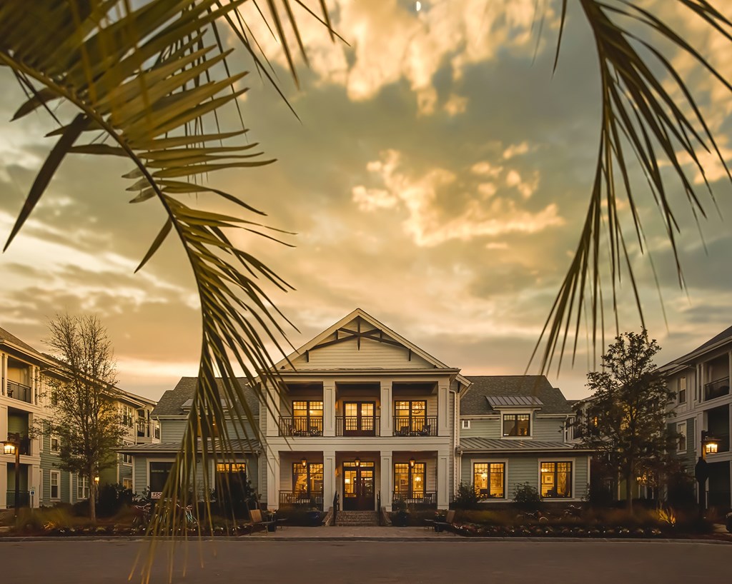 A large house with a palm tree in front of it at Wharf 7 Apartments, Charleston, SC 29492