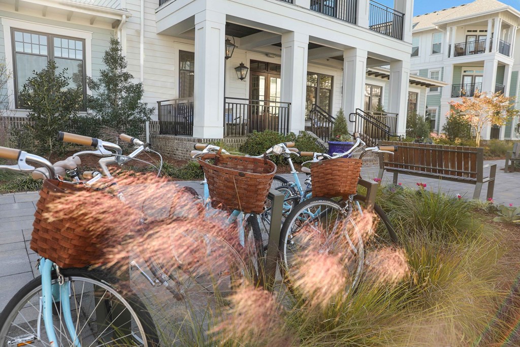 Two bicycles with baskets are parked in front of a house at Wharf 7 Apartments, South Carolina