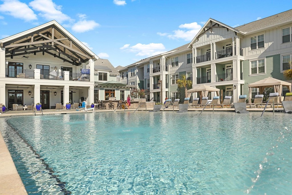 A large swimming pool in front of a resort-style building at Wharf 7 Apartments, Charleston, South Carolina