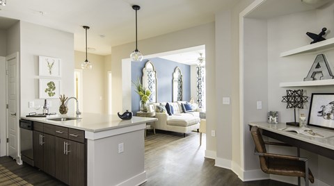A kitchen with a white counter and a brown chair.
