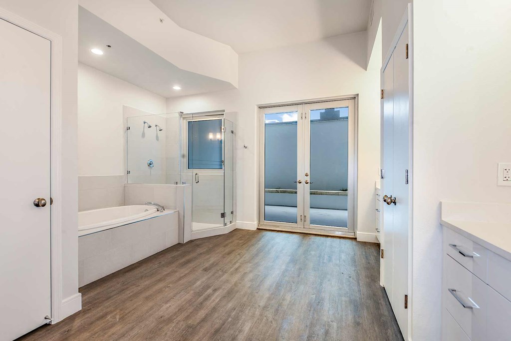 a master bathroom with a soaking tub and a walk in shower at Paramount on Lake Eola, Orlando, FL