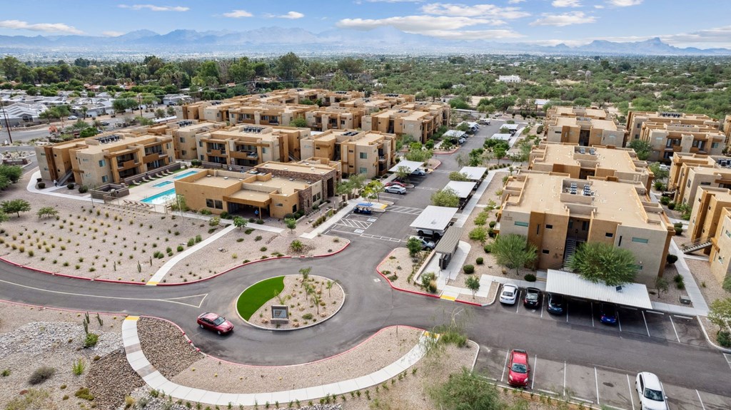 an aerial view of a housing complex with a roundabout in the middle of the road at Pima Canyon, Tucson, Arizona
