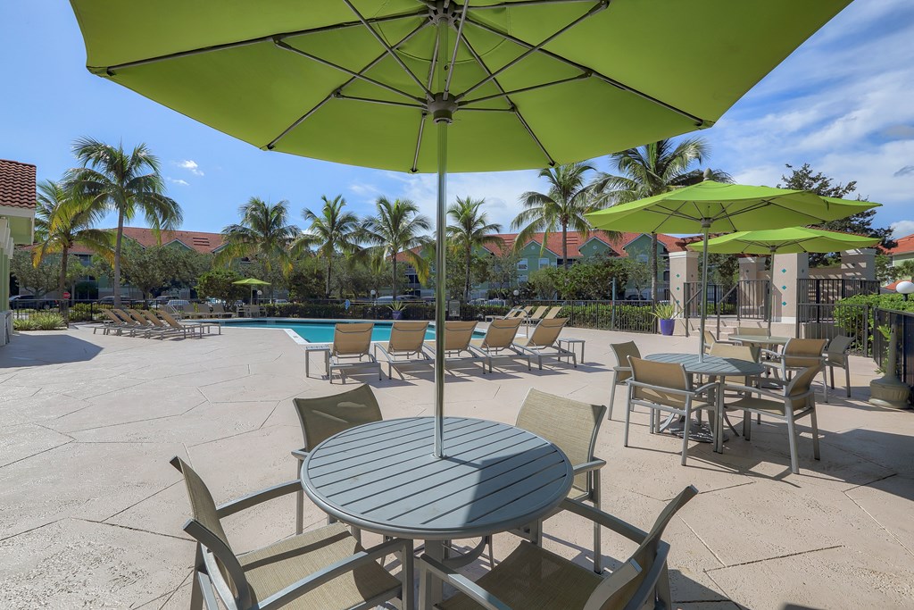 Poolside tables and umbrellas at Monterra at Bonita Springs, Bonita Springs, Florida