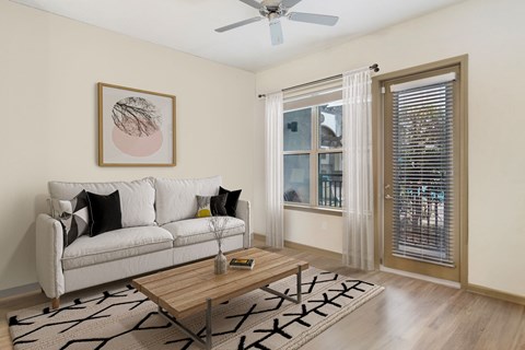 a living room with a couch and a coffee table at The Rialto, Orlando, FL, 32819