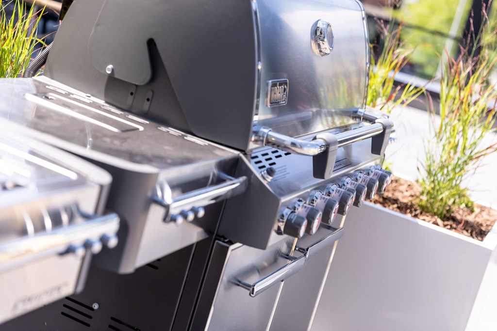 an outdoor grill with the door open and a grill grate on it at Maven on Broadway, Rochester, MN