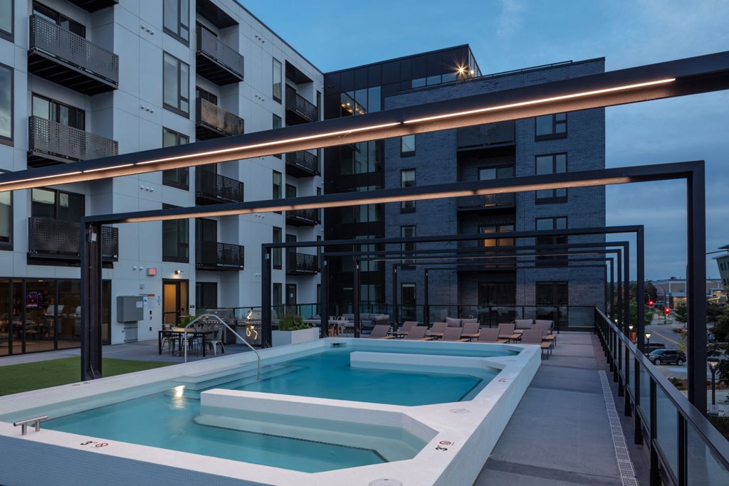 a pool in front of an apartment building at night at Maven on Broadway, Rochester, Minnesota