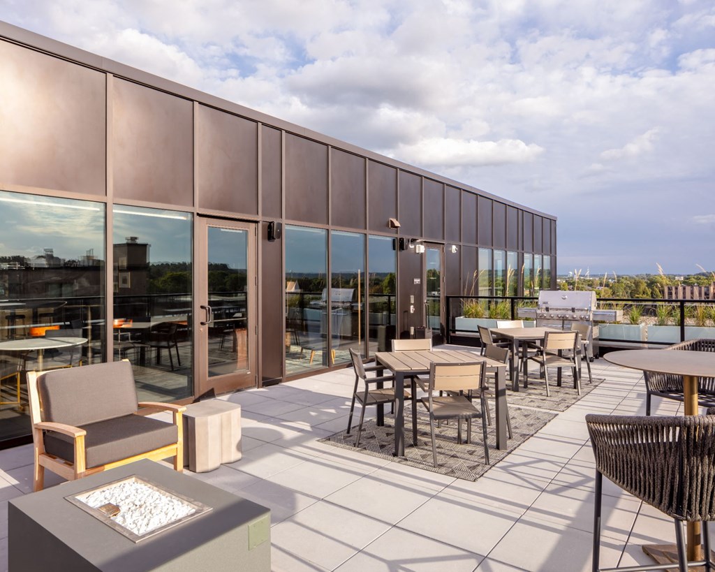 a patio with tables and chairs on the roof of a building at Maven on Broadway, Minnesota