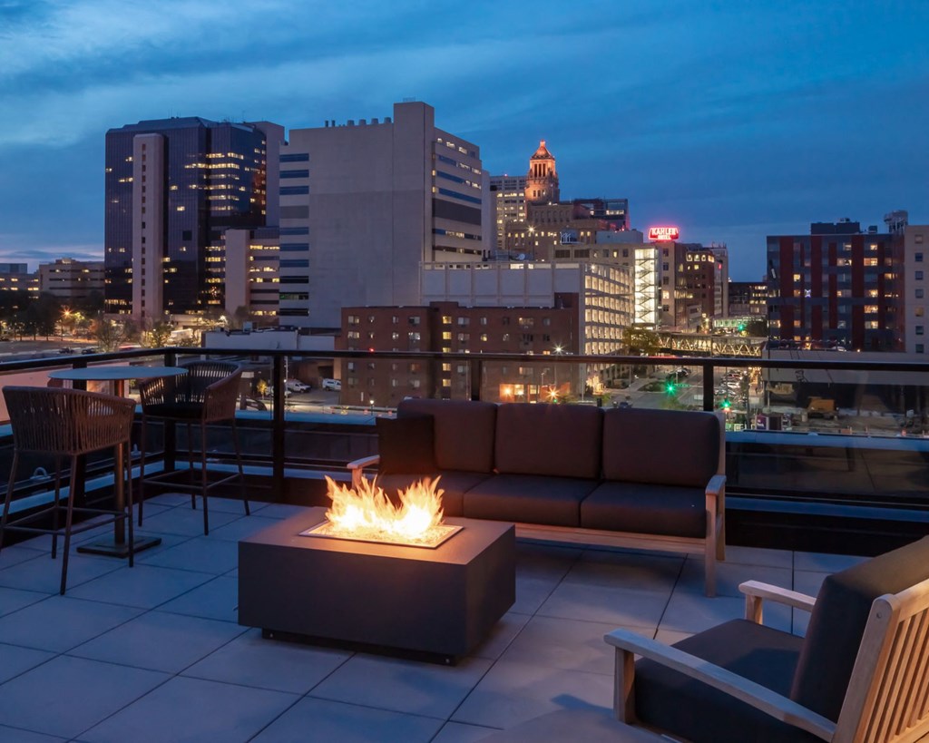 a rooftop fire pit with a city skyline in the background at Maven on Broadway, Minnesota, 55904