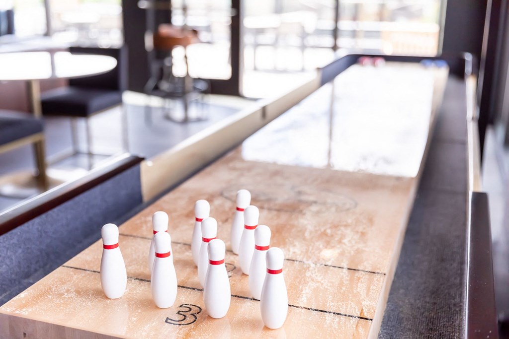 a row of bowling pins on a shuffleboard court at Maven on Broadway, Rochester, MN, 55904