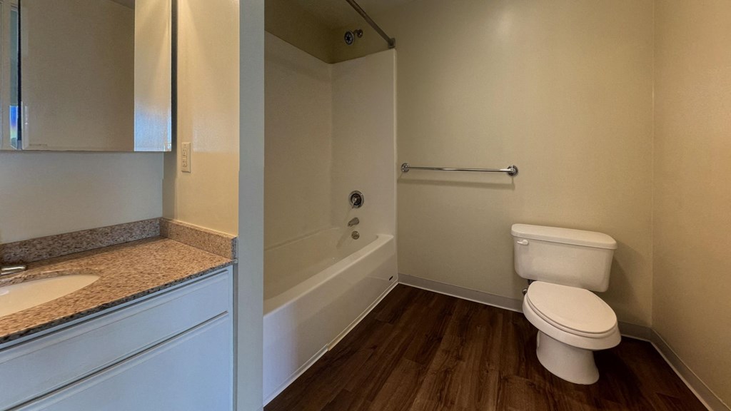 a bathroom with a toilet and a tub and a sink