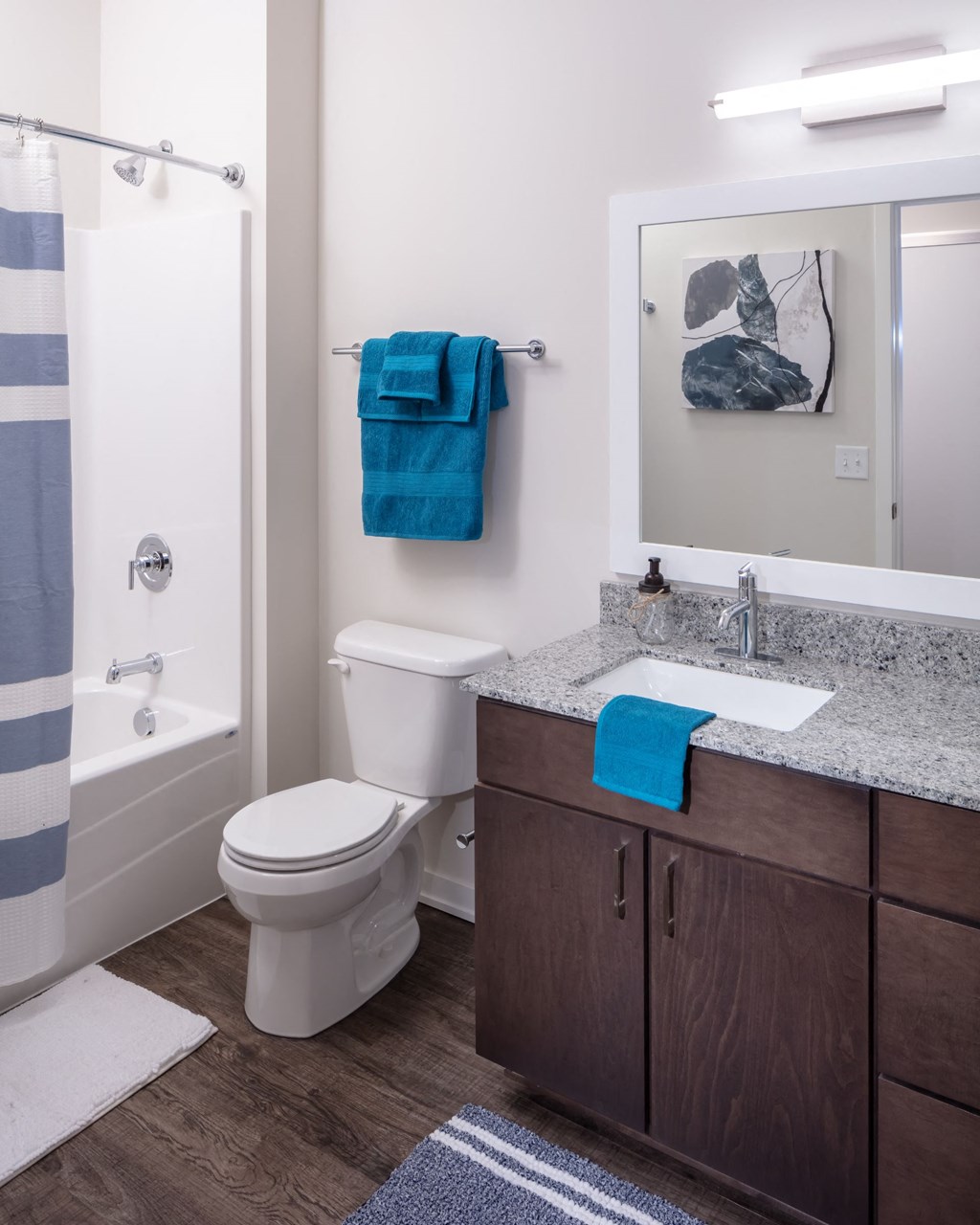 a bathroom with a shower toilet sink and mirror at Maven on Broadway, Rochester, MN, 55904