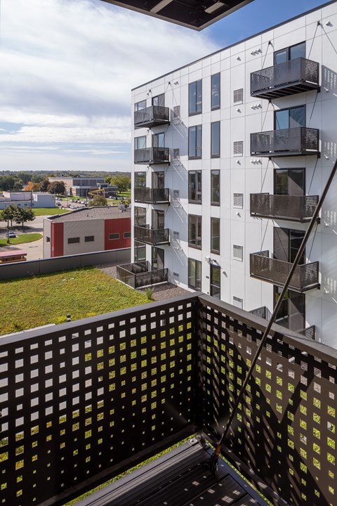 a view of an apartment building from a balcony at Maven on Broadway Apartments, Rochester, MN