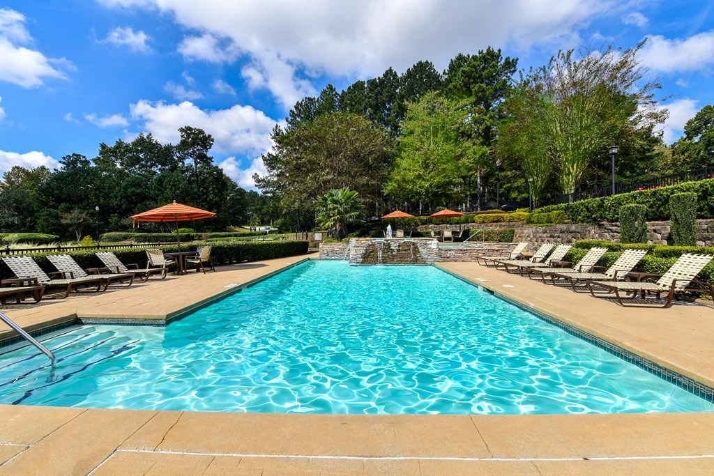 a swimming pool with lounge chairs and umbrellas at 670 Thornton, Lithia Springs, 30122