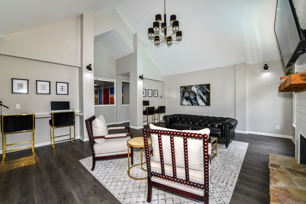 a living room with a black couch and white chairs at 670 Thornton, Lithia Springs, 30122