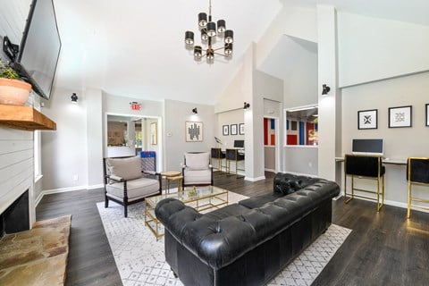 a living room with a black leather couch and two chairs at 670 Thornton, Georgia