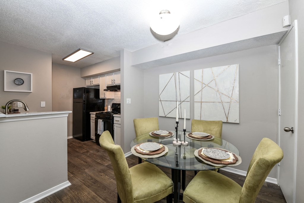 a dining area with a glass table and yellow chairs at 670 Thornton, Georgia