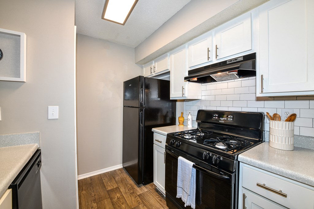 a kitchen with white cabinets and black appliances at 670 Thornton, Lithia Springs, Georgia