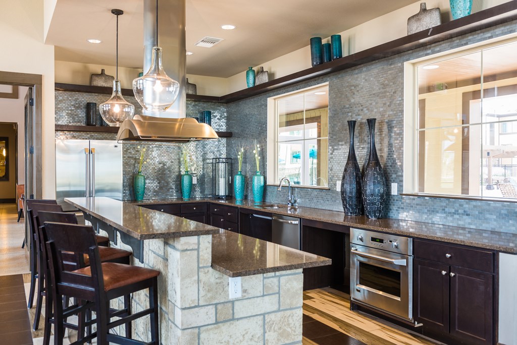 a kitchen with a large counter and chairsat Estate at Woodmen Ridge, Colorado Springs, CO