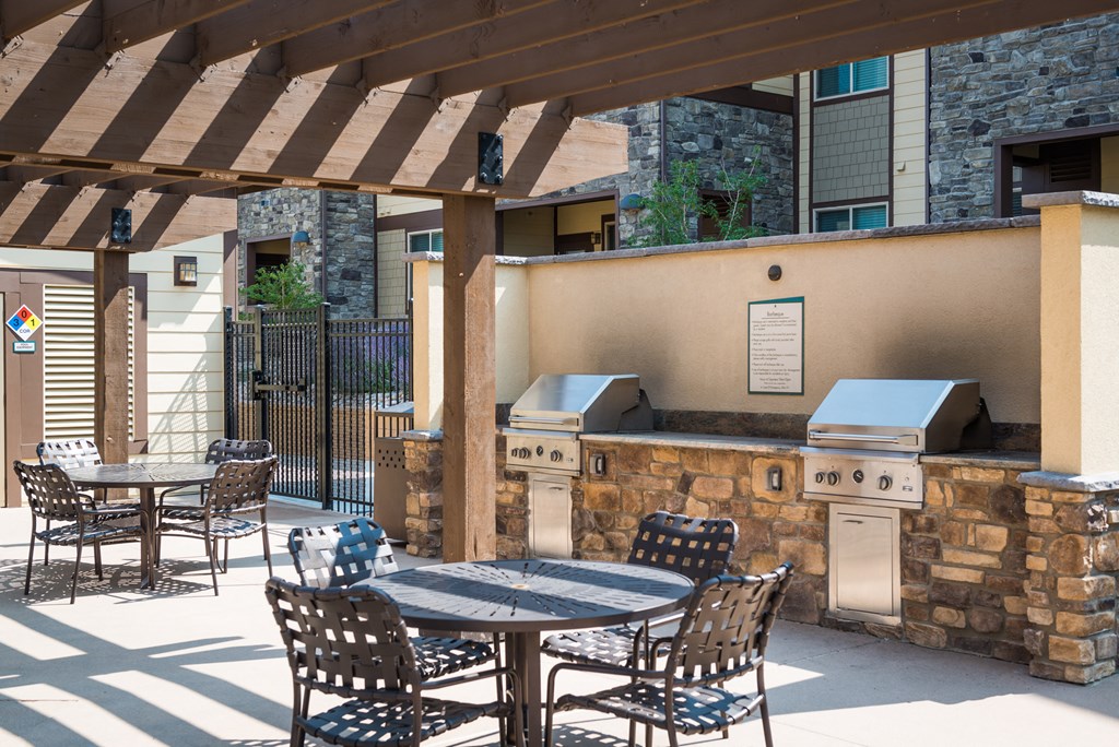 a patio with a table and chairs and a grill at Estate at Woodmen Ridge, Colorado Springs, 80923