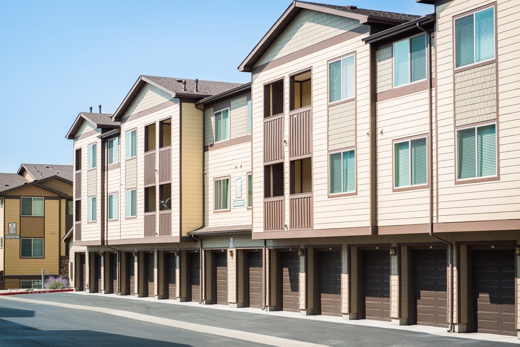 an empty street in front of a row of town houses at Estate at Woodmen Ridge, Colorado, 80923