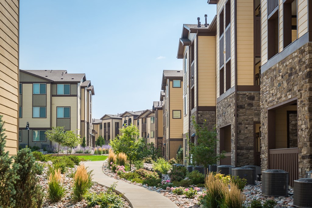 a row of townhouses with a sidewalk in front of them at Estate at Woodmen Ridge, Colorado Springs Colorado