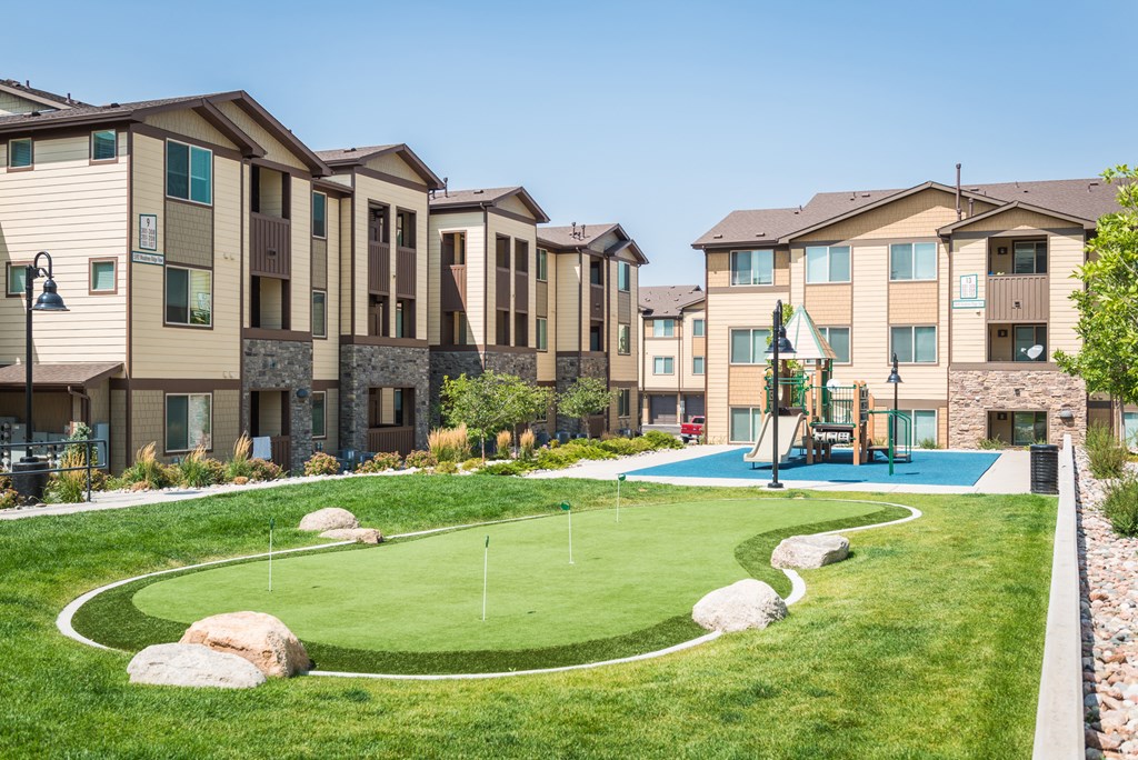 an outdoor basketball court in front of a row of houses at Estate at Woodmen Ridge, Colorado Springs Colorado