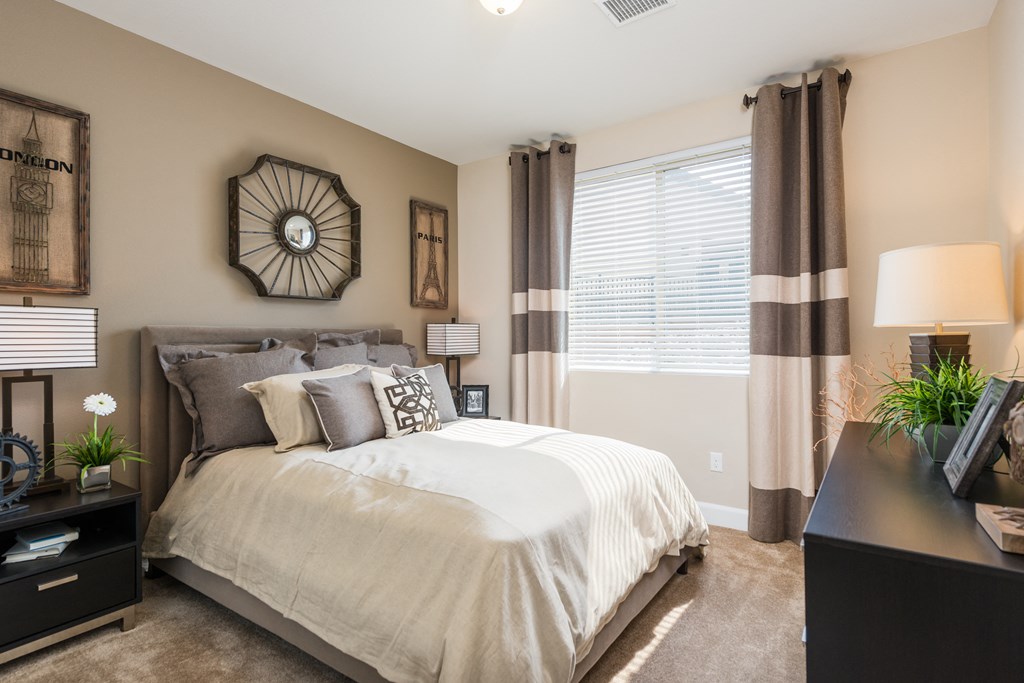 an empty bedroom with a bed and a windowat Estate at Woodmen Ridge, Colorado Springs, 80923