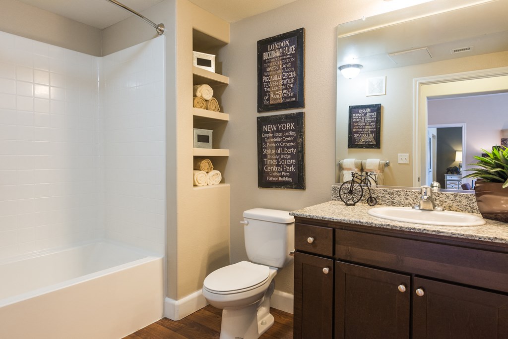 a bathroom with a toilet sink and shower and a mirrorat Estate at Woodmen Ridge, Colorado Springs, CO 80923