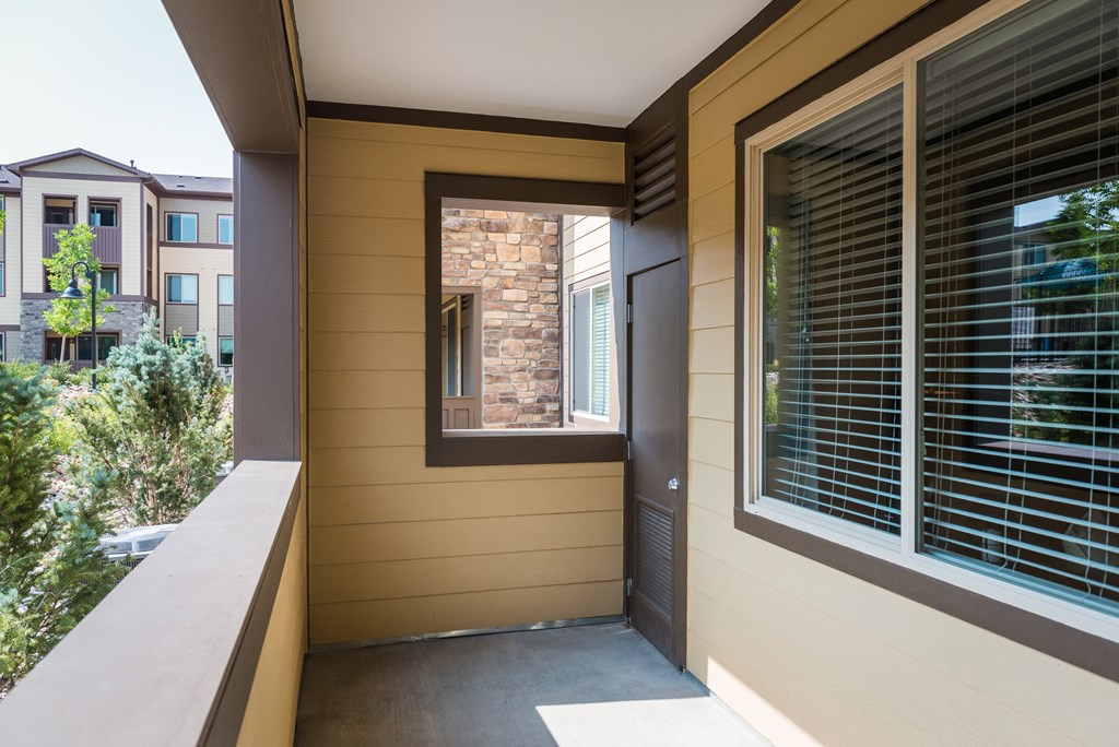 side view of the front porch of a home with a large window at Estate at Woodmen Ridge, Colorado Springs Colorado