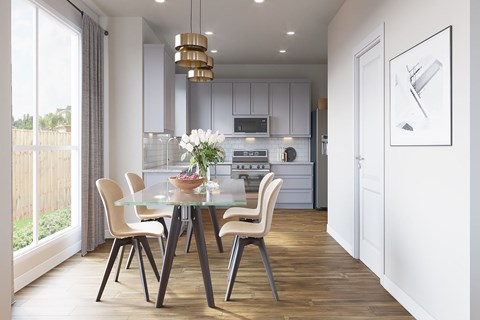 A modern kitchen with a glass dining table and chairs.