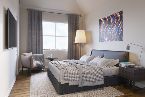 A bedroom with a large bed and a painting on the wall.